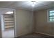 Room with neutral walls, carpet, and built in shelving at 3026 Hidden Forest Dr, Snellville, GA 30078