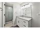 Bathroom with updated vanity, granite countertop, and a shower with a glass door at 3304 Pine Heights Ne Dr, Atlanta, GA 30324