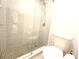 Bright bathroom with a glass shower, tile flooring, and a modern toilet at 3304 Pine Heights Ne Dr, Atlanta, GA 30324