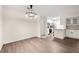 Bright dining area featuring modern light fixture, hardwood floors and open view into the kitchen at 3304 Pine Heights Ne Dr, Atlanta, GA 30324
