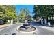 Gated entrance to the community with a beautiful water fountain and lush landscaping at 3304 Pine Heights Ne Dr, Atlanta, GA 30324