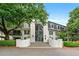 Elegant condo building featuring a grand entrance, mature trees, and beautifully landscaped grounds at 3304 Pine Heights Ne Dr, Atlanta, GA 30324