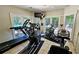 Bright fitness center featuring multiple machines and natural light with pool view at 3304 Pine Heights Ne Dr, Atlanta, GA 30324
