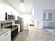 Galley kitchen with stainless appliances, white cabinets, and granite countertops at 3304 Pine Heights Ne Dr, Atlanta, GA 30324