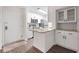 Modern white kitchen featuring stainless steel appliances, granite countertops, and ample cabinet space at 3304 Pine Heights Ne Dr, Atlanta, GA 30324