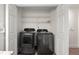 Laundry room with new washer and dryer, storage shelves, and bright lighting at 3304 Pine Heights Ne Dr, Atlanta, GA 30324