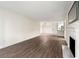 Spacious living space featuring fireplace, kitchen, and stylish light fixture at 3304 Pine Heights Ne Dr, Atlanta, GA 30324