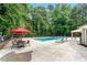 Community pool with lounge chairs and umbrella-covered tables at 3304 Pine Heights Ne Dr, Atlanta, GA 30324
