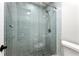 Updated shower with sleek, light blue tiling and modern fixtures at 3304 Pine Heights Ne Dr, Atlanta, GA 30324