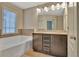 Bathroom featuring a double sink vanity, a large mirror with vanity lighting, and a soaking tub at 2243 Knoxhill Se Vw, Smyrna, GA 30082