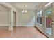 Well-lit dining room showcasing hardwood floors, elegant chandelier, and a glass door providing outdoor access at 2243 Knoxhill Se Vw, Smyrna, GA 30082