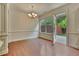 Bright dining room featuring hardwood floors, a stylish chandelier, and a glass door leading to the patio at 2243 Knoxhill Se Vw, Smyrna, GA 30082