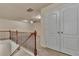 Upstairs landing with wood railing and neutral carpet at 2243 Knoxhill Se Vw, Smyrna, GA 30082