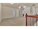 Upstairs landing with wood railing and neutral carpet at 2243 Knoxhill Se Vw, Smyrna, GA 30082