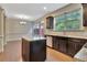 Open kitchen with granite countertops, stainless steel appliances, a center island, and dark brown cabinetry at 2243 Knoxhill Se Vw, Smyrna, GA 30082
