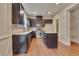 Modern kitchen with stainless steel appliances, granite countertops, and dark brown cabinetry with island at 2243 Knoxhill Se Vw, Smyrna, GA 30082
