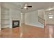 Well-lit living room with fireplace, hardwood floors, and staircase access at 2243 Knoxhill Se Vw, Smyrna, GA 30082