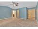 Spacious main bedroom featuring blue walls, neutral carpet, and a ceiling fan at 2243 Knoxhill Se Vw, Smyrna, GA 30082