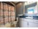 Cozy bathroom with a shower-tub combo, framed mirror, and vanity with black countertop at 3445 Stratford Rd # 1501, Atlanta, GA 30326