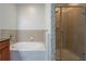 Bathroom featuring soaking tub and tiled shower at 3445 Stratford Rd # 1501, Atlanta, GA 30326