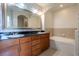 Bathroom featuring double sinks, granite counters, and a soaking tub at 3445 Stratford Rd # 1501, Atlanta, GA 30326