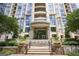 Elegant building entrance with stone accents, manicured landscaping, and a welcoming water feature at 3445 Stratford Rd # 1501, Atlanta, GA 30326