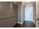 Elegant hallway featuring decorative wall treatments, hardwood floors, and ample closet space at 3445 Stratford Rd # 1501, Atlanta, GA 30326
