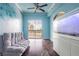 Open living area with unique blue wall design, balcony access, and a built-in aquarium at 3445 Stratford Rd # 1501, Atlanta, GA 30326
