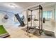 Basement workout area with weight rack, treadmill, and punching bag near stairs at 3861 Hanover Ct, Marietta, GA 30062