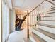 Basement stairs with white painted wood trim and a glimpse of exercise equipment at 3861 Hanover Ct, Marietta, GA 30062