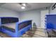 Blue bedroom with hardwood floors and a blue bed and dresser at 3861 Hanover Ct, Marietta, GA 30062