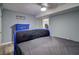 Bedroom with light blue walls, gray floors, and a blue dresser at 3861 Hanover Ct, Marietta, GA 30062