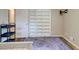 Bedroom featuring a purple rug, wood floors, and a closet with open shelving at 3861 Hanover Ct, Marietta, GA 30062