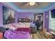 Bedroom with purple walls, wood floors, a ceiling fan, and a window with blinds at 3861 Hanover Ct, Marietta, GA 30062