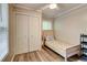 Bedroom featuring a twin bed, wood floors, closet with doors, and a window with blinds at 3861 Hanover Ct, Marietta, GA 30062