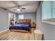 Bedroom with blue walls, wood floors, a ceiling fan, and a closet with clothes at 3861 Hanover Ct, Marietta, GA 30062