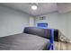 Bedroom with light blue walls and a large blue bed; ceiling fan and gray flooring at 3861 Hanover Ct, Marietta, GA 30062
