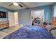 Bedroom with blue walls, wood floors, a ceiling fan, and a closet with clothes at 3861 Hanover Ct, Marietta, GA 30062
