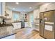 Eat-in kitchen featuring granite countertops, white cabinets, stainless steel appliances, and hardwood floors at 3861 Hanover Ct, Marietta, GA 30062