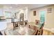 Modern eat-in kitchen featuring white cabinets, stainless steel appliances, and a glass dining table at 3861 Hanover Ct, Marietta, GA 30062