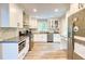 Eat-in kitchen featuring granite countertops, white cabinets, stainless steel appliances, and hardwood floors at 3861 Hanover Ct, Marietta, GA 30062
