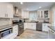 Modern eat-in kitchen featuring granite countertops, white cabinets, and stainless steel appliances at 3861 Hanover Ct, Marietta, GA 30062
