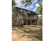 View of the home's backyard, featuring a covered porch and ample green space at 1055 Worthington Hills Dr, Roswell, GA 30076