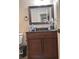 Bathroom featuring granite counters, framed mirror, and vanity with dark wood cabinets at 1055 Worthington Hills Dr, Roswell, GA 30076