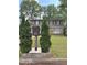 Two-story home featuring a mailbox at street level with green landscaping at 1055 Worthington Hills Dr, Roswell, GA 30076
