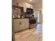 Modern kitchen with shaker cabinets, black hardware, and stainless steel appliances at 1055 Worthington Hills Dr, Roswell, GA 30076