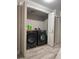 Laundry room with side-by-side washer and dryer behind bi-fold closet doors at 1055 Worthington Hills Dr, Roswell, GA 30076