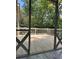 Covered back porch featuring decorative carpentry and refinished wood floor at 1055 Worthington Hills Dr, Roswell, GA 30076