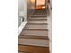Carpet free staircase with wood treads and white risers leading to the upper level of the home at 1055 Worthington Hills Dr, Roswell, GA 30076