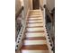 Staircase with wooden stairs, white risers, and an ornate, wrought iron railing at 1055 Worthington Hills Dr, Roswell, GA 30076